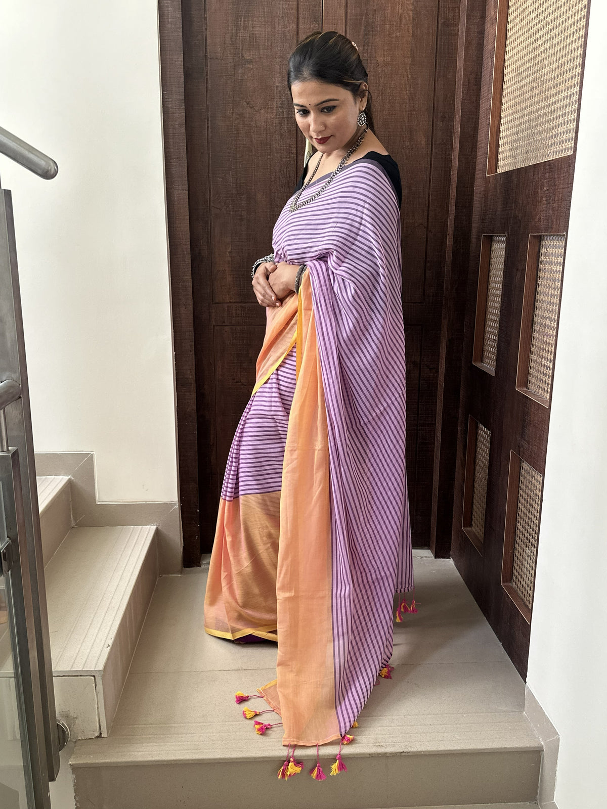 Purple and peach half-and-half mul cotton saree with stripe detailing.