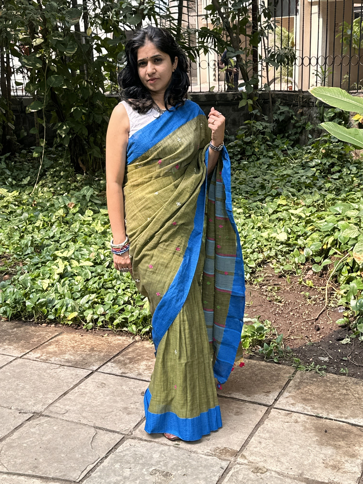 Green handwoven khadi cotton saree with contrast blue border.