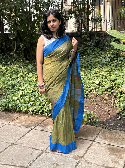Green handwoven khadi cotton saree with contrast blue border.