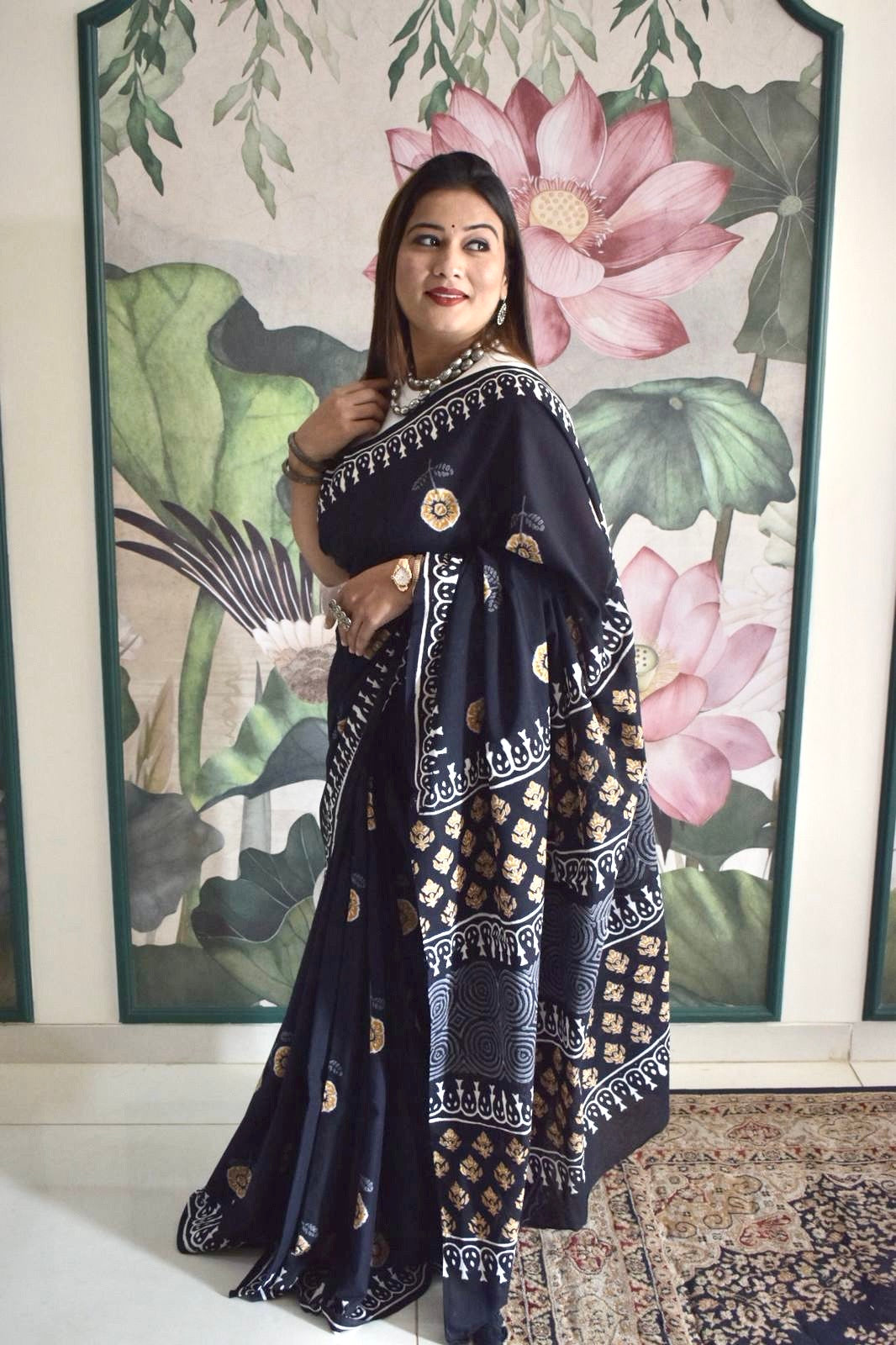 Black mul cotton saree with mustard floral handblock Bagru print.