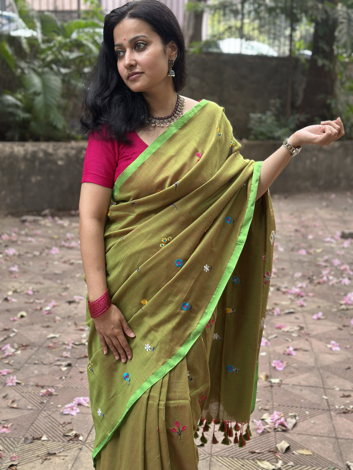 Olive green dual-tone mul cotton saree with floral embroidery.