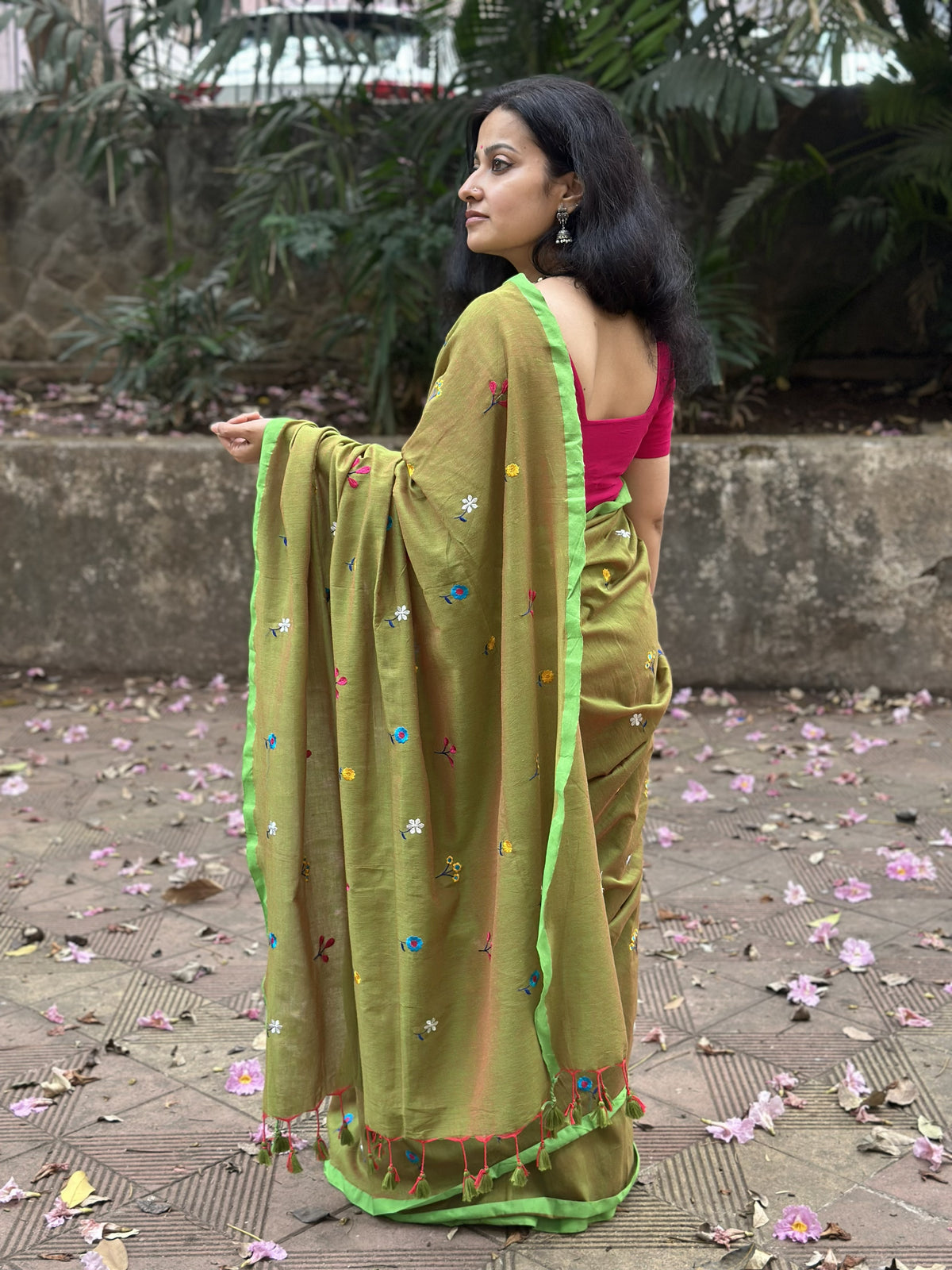 Olive green dual-tone mul cotton saree with floral embroidery.