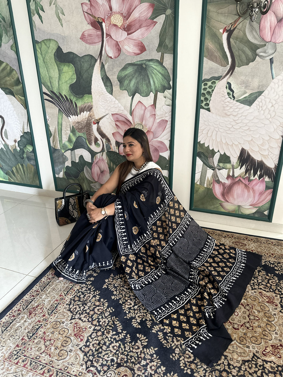 Black mul cotton saree with mustard floral handblock Bagru print.
