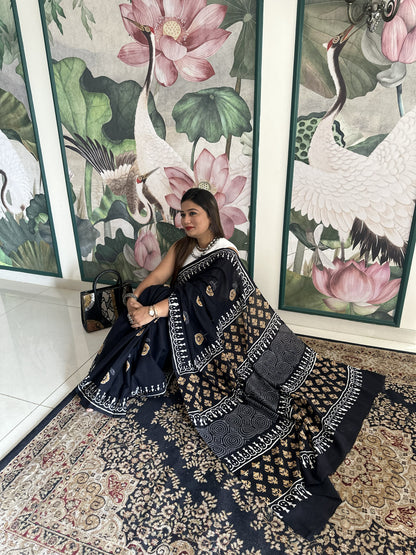 Black mul cotton saree with mustard floral handblock Bagru print.