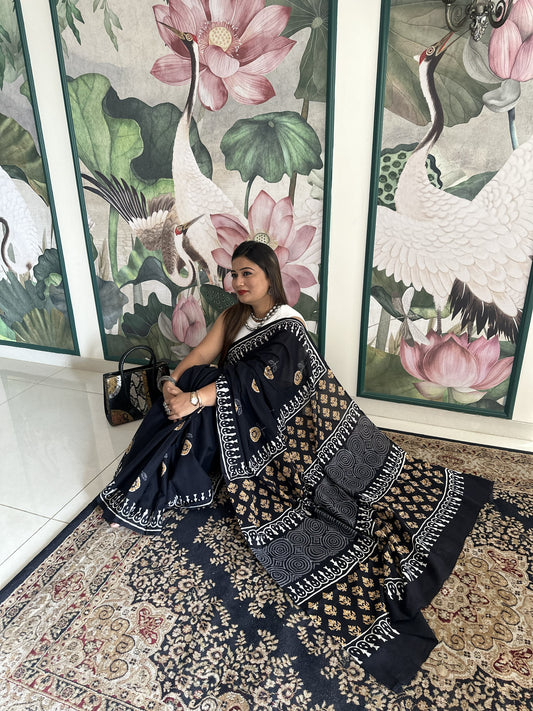 Black mul cotton saree with mustard floral handblock Bagru print.