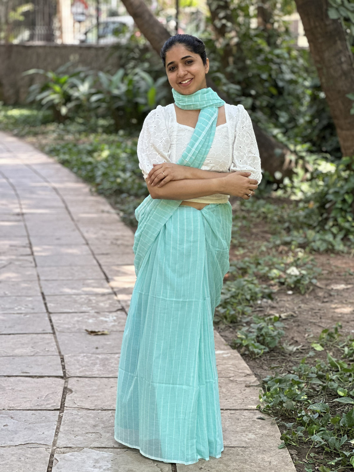 Light blue mul cotton saree with subtle white stripes.
