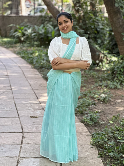 Light blue mul cotton saree with subtle white stripes.