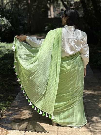 Light green mul cotton saree with subtle white stripes.