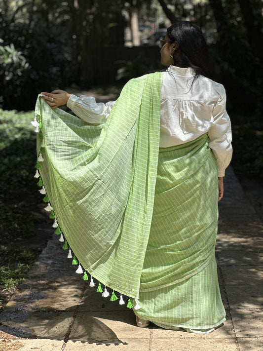 Light green mul cotton saree with subtle white stripes.