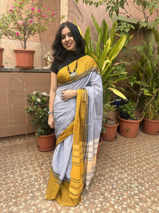 Grey Dhonekhali cotton saree with yellow border