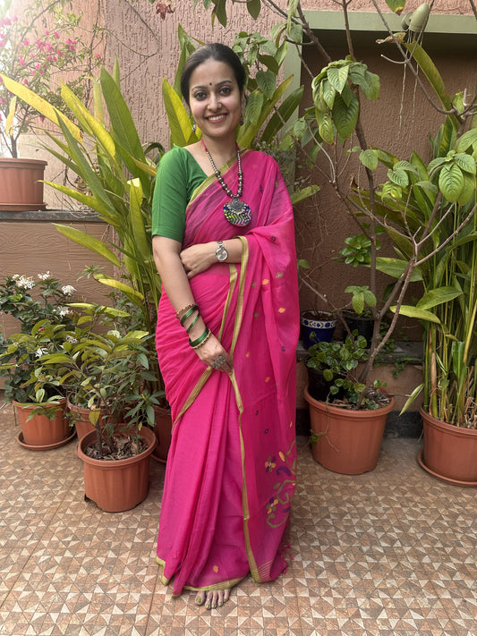 Pink handloom cotton Jamdani saree with multicolour buttis and green border.