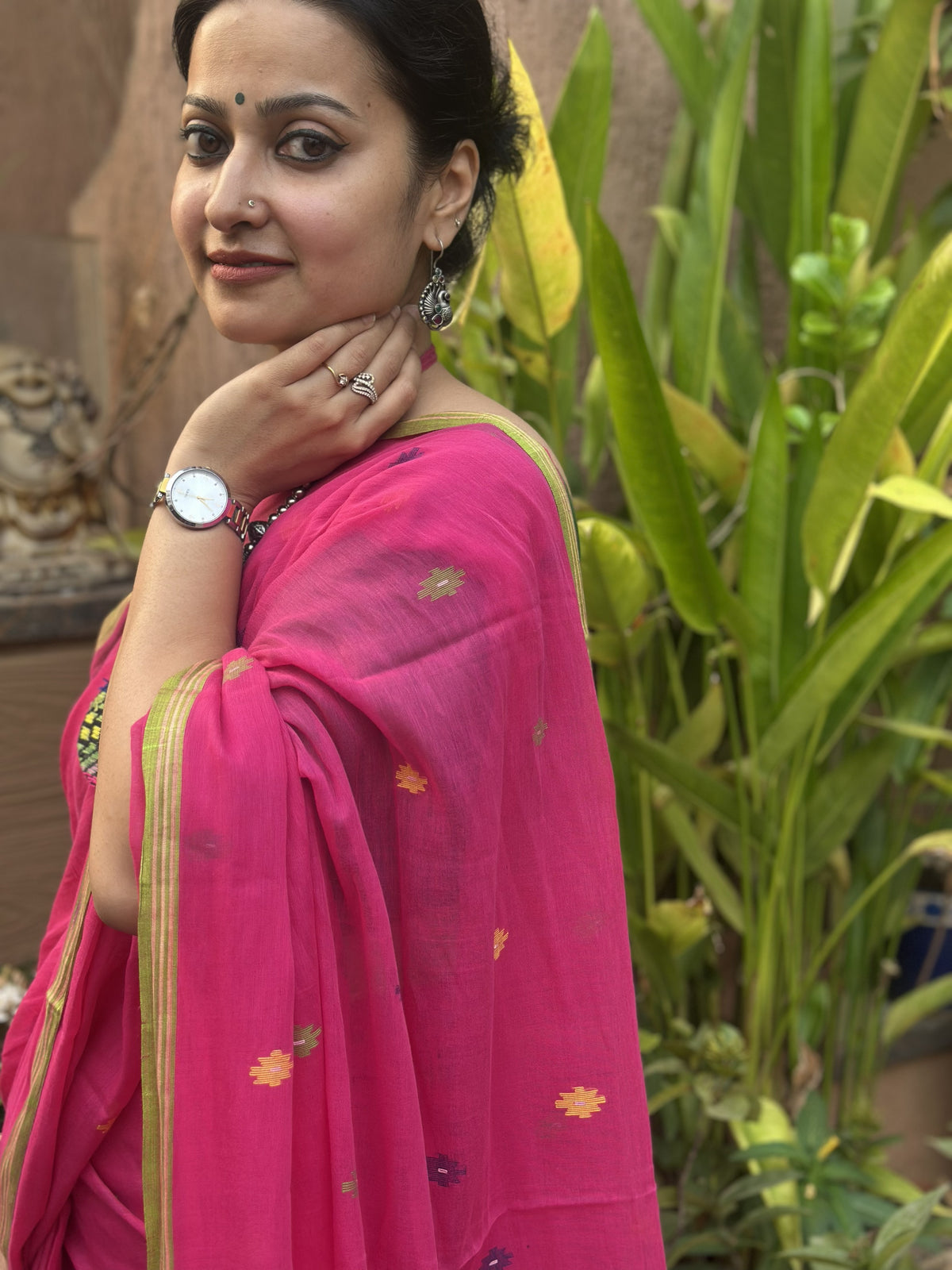 Pink handloom cotton Jamdani saree with multicolour buttis and green border.