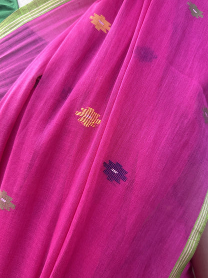Pink handloom cotton Jamdani saree with multicolour buttis and green border.