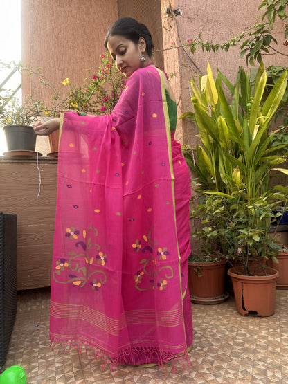 Pink handloom cotton Jamdani saree with multicolour buttis and green border.