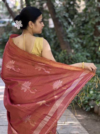 Red tissue linen handloom saree with elegant lotus and leaf motifs.