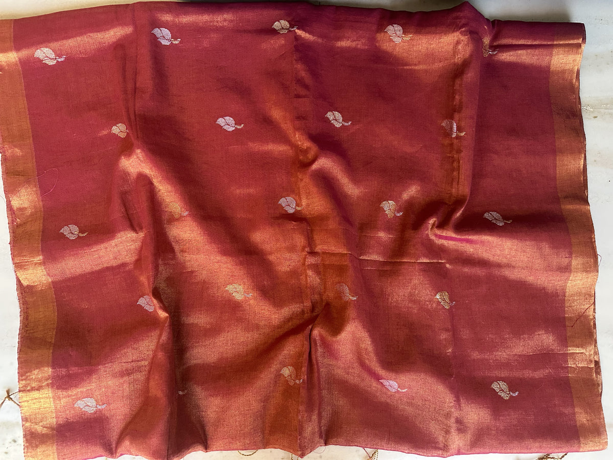 Red tissue linen handloom saree with elegant lotus and leaf motifs.