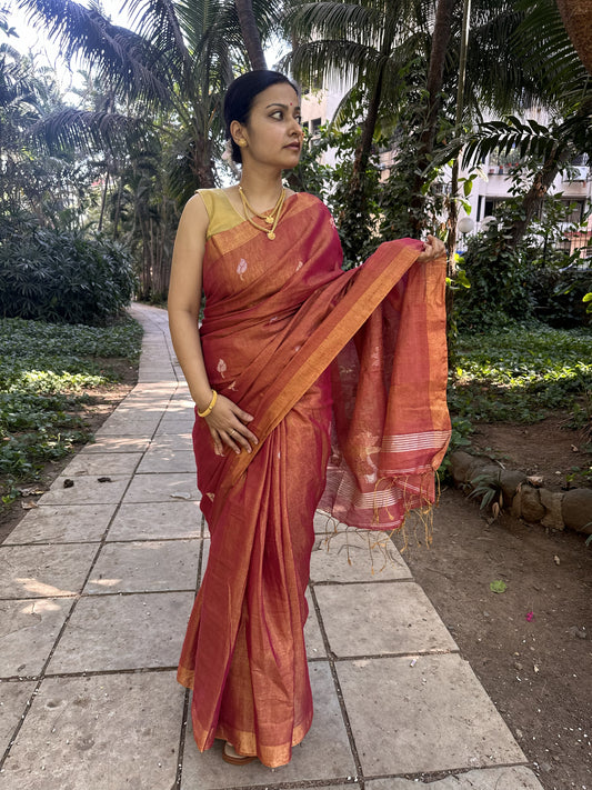 Red tissue linen handloom saree with elegant lotus and leaf motifs.